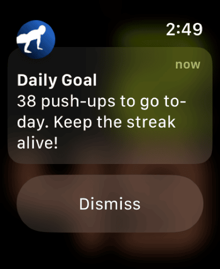 A PushFit reminder notification on the watch reading: 38 push-ups to go today. Keep the streak alive!